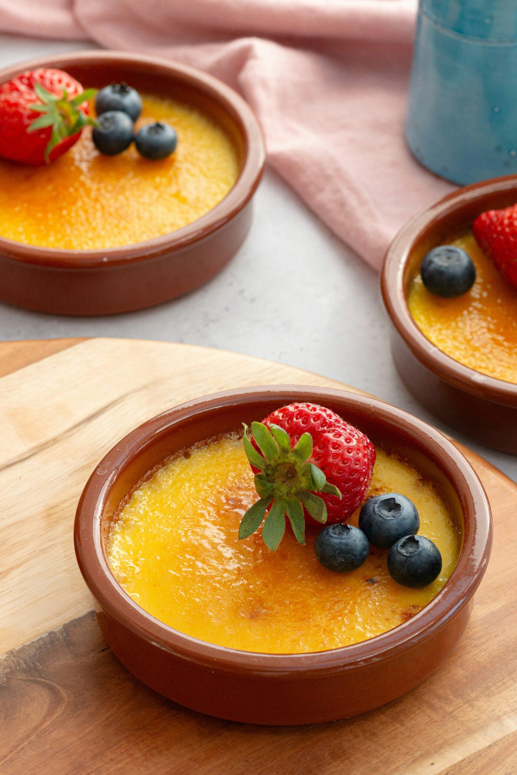 Blog gourmet crème brûlée dessert with strawberry and blueberry
