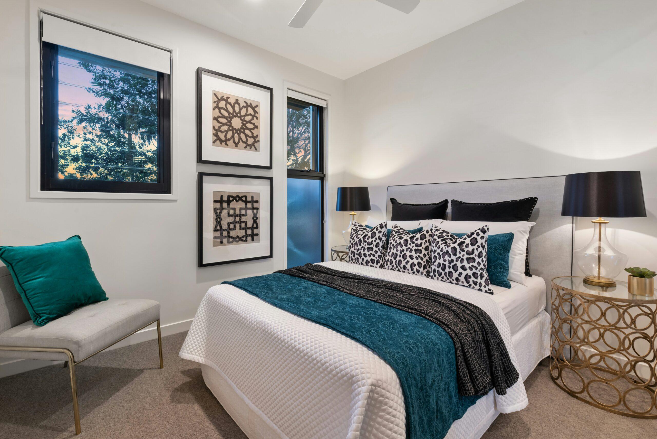 modern master bedroom with queen bed and artwork
