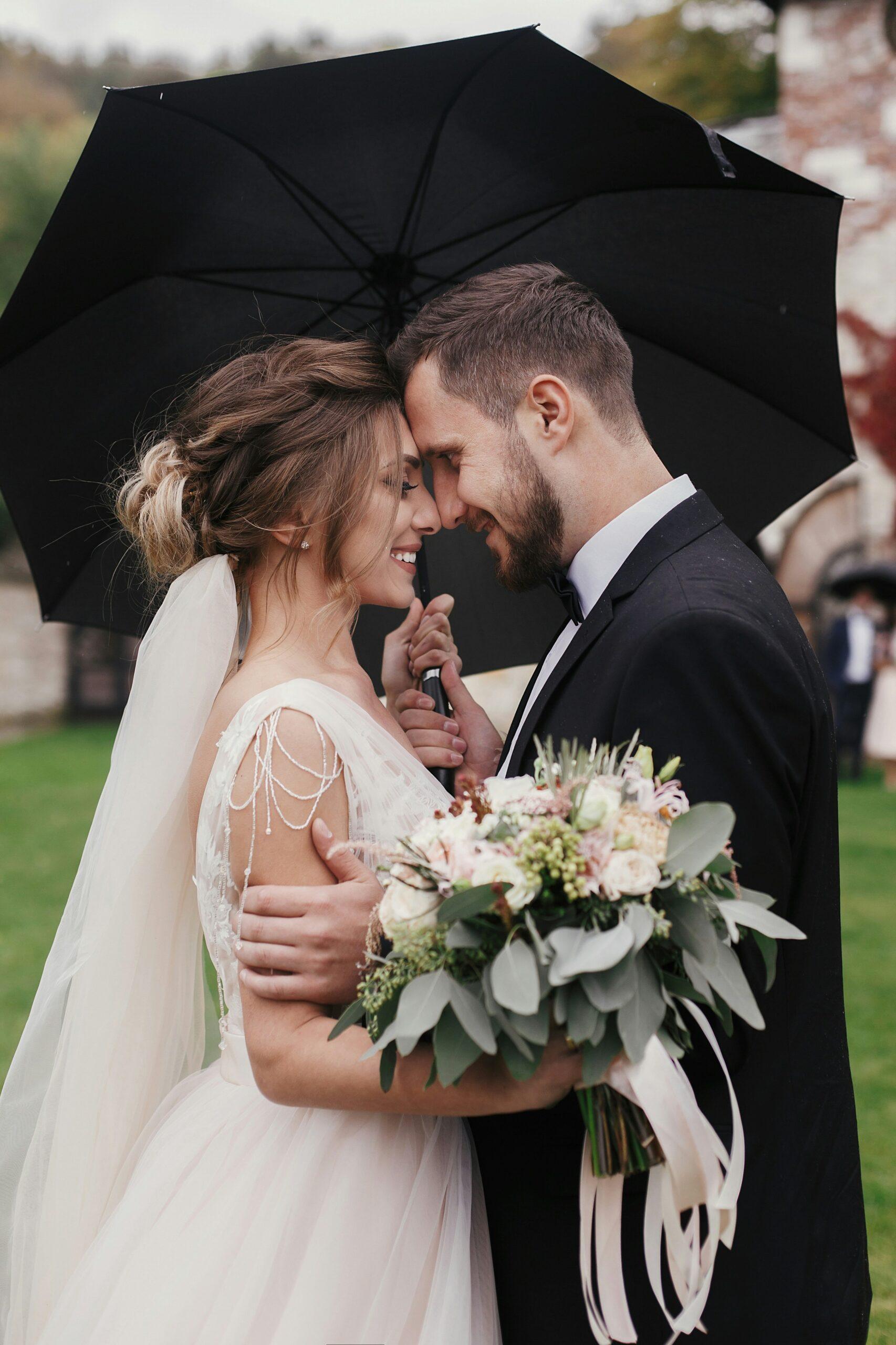 romantic rainy wedding portrait of bride and groom