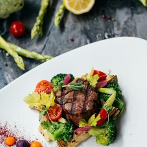 food photography of a beautifully plated meat and vegetable dish